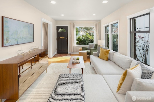 living area featuring light wood-style flooring and recessed lighting