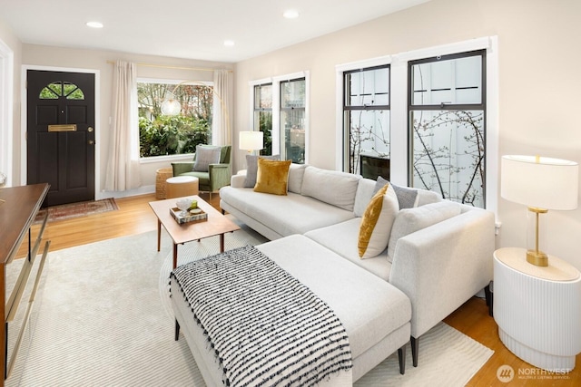 living area featuring light wood-style flooring and recessed lighting