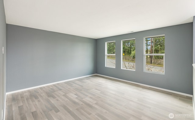 empty room featuring baseboards and wood finished floors