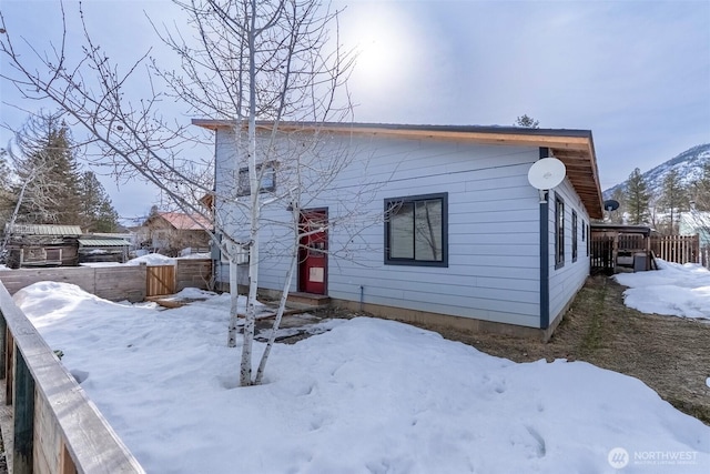 view of front of home featuring entry steps and fence