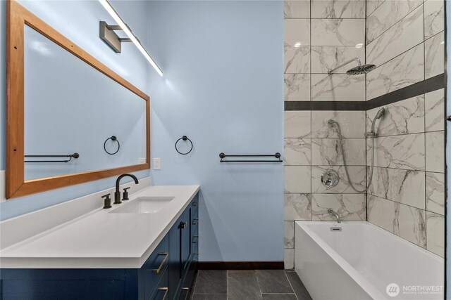 bathroom featuring vanity, baseboards, and shower / bath combination