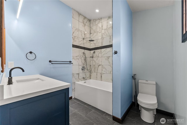 bathroom featuring vanity, toilet, shower / bathtub combination, and baseboards