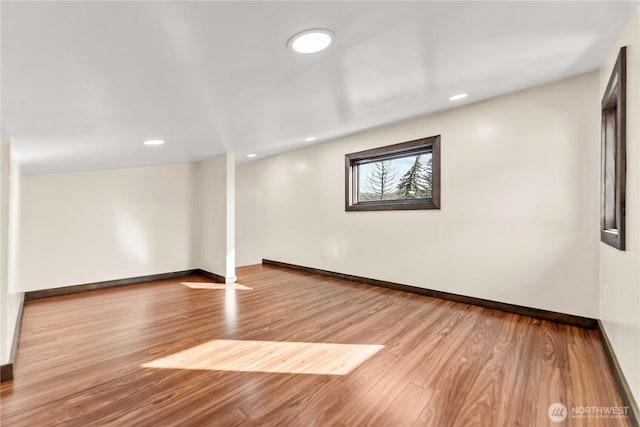 basement featuring recessed lighting, wood finished floors, and baseboards