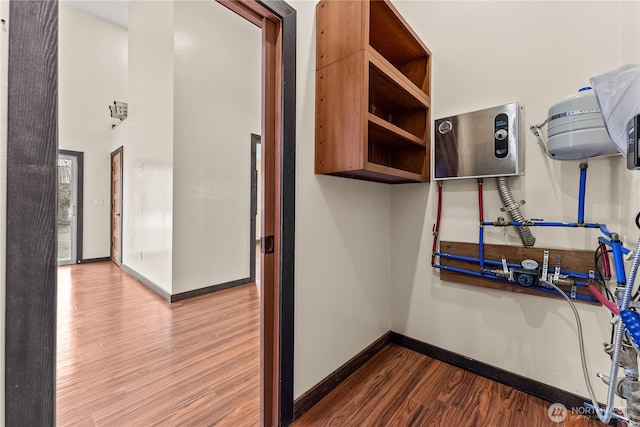 interior space featuring baseboards and wood finished floors