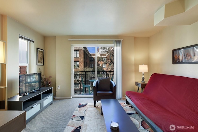 carpeted living area with baseboards