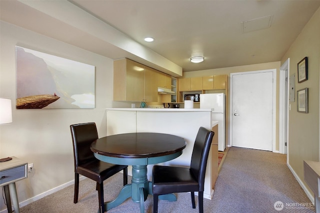 carpeted dining room with recessed lighting and baseboards