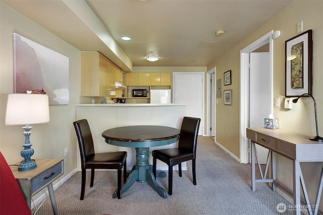 dining area featuring baseboards and carpet flooring