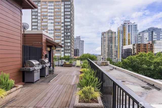 deck featuring a view of city and area for grilling