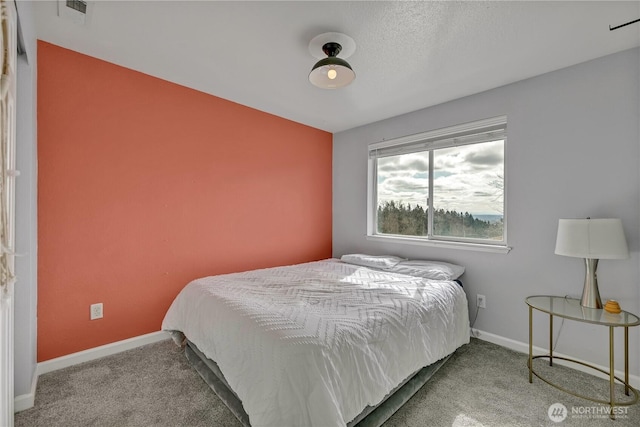 carpeted bedroom with baseboards and visible vents