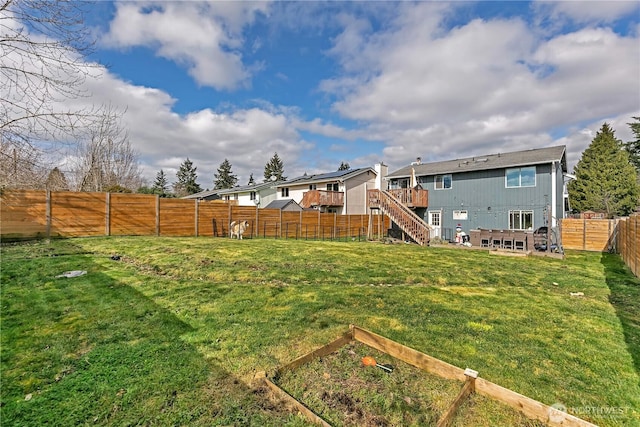 view of yard featuring stairway, a fenced backyard, and a wooden deck