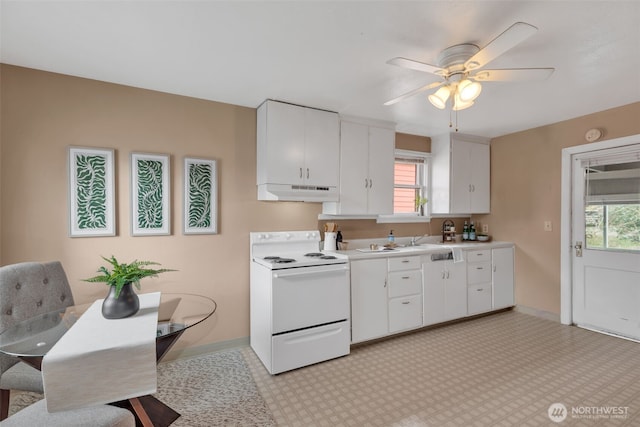 kitchen featuring white electric range oven, baseboards, light countertops, white cabinets, and under cabinet range hood