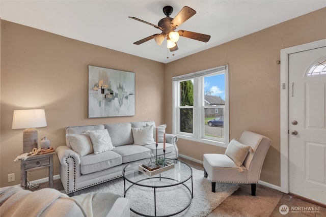 carpeted living room with baseboards and ceiling fan