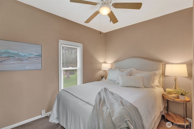 carpeted bedroom featuring baseboards and ceiling fan