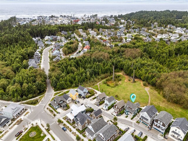 drone / aerial view featuring a residential view and a water view