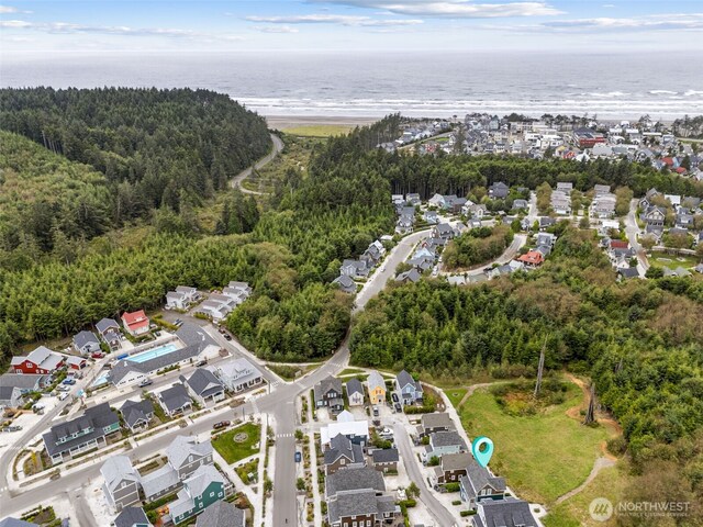 drone / aerial view featuring a residential view and a water view