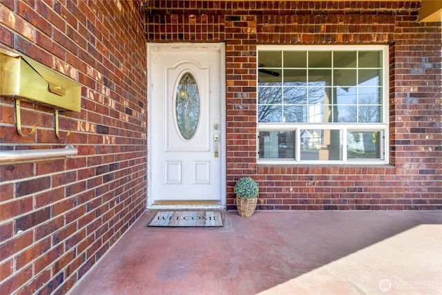 doorway to property with brick siding