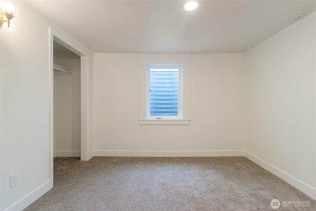 unfurnished bedroom featuring carpet and baseboards