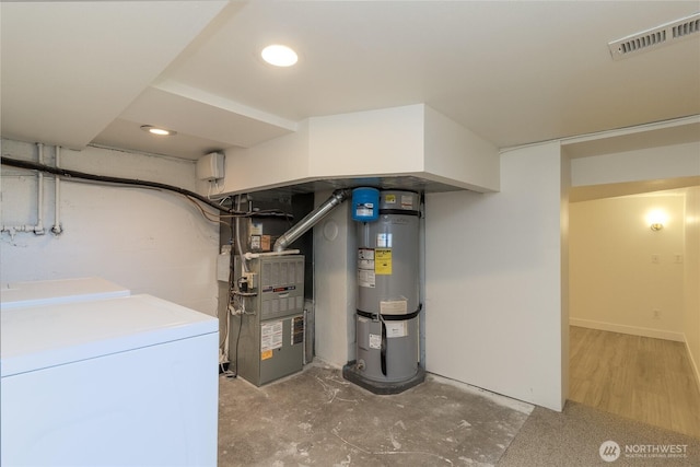 utilities featuring visible vents, independent washer and dryer, secured water heater, and heating unit