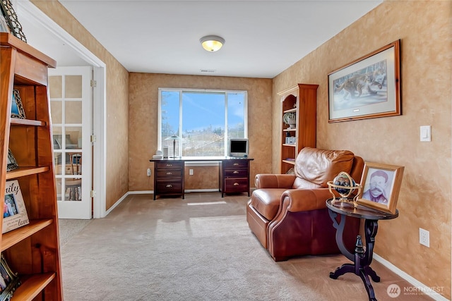 living area featuring carpet flooring and baseboards