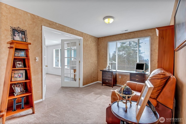 home office with visible vents, light colored carpet, french doors, and baseboards