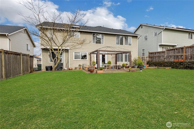 rear view of house with a patio area, a fenced backyard, and a yard