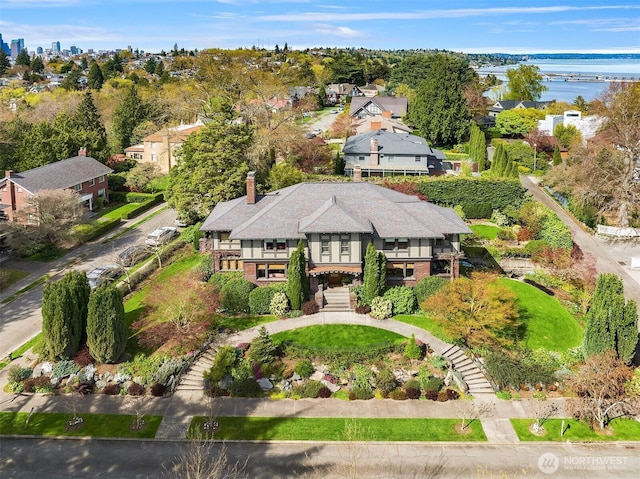 birds eye view of property with a water view