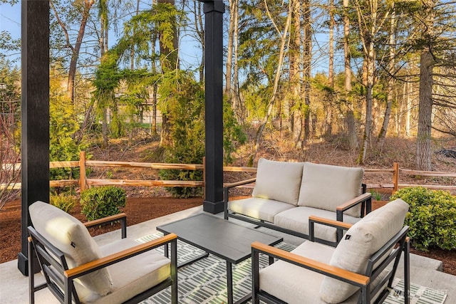 view of patio / terrace featuring outdoor lounge area and fence