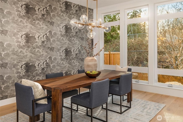 dining space featuring an inviting chandelier and wood finished floors