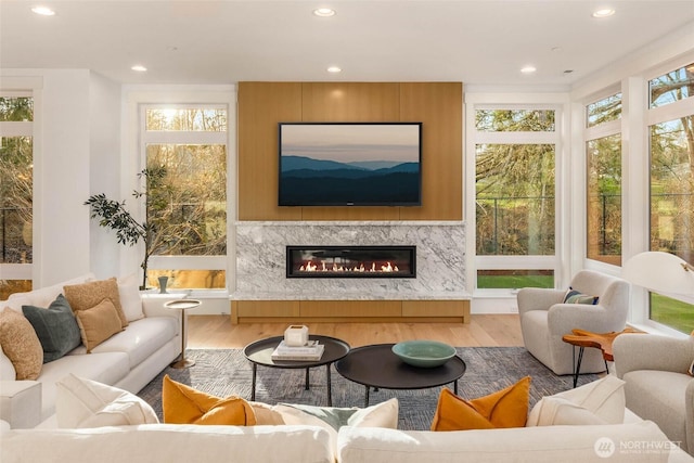 sunroom with plenty of natural light and a fireplace