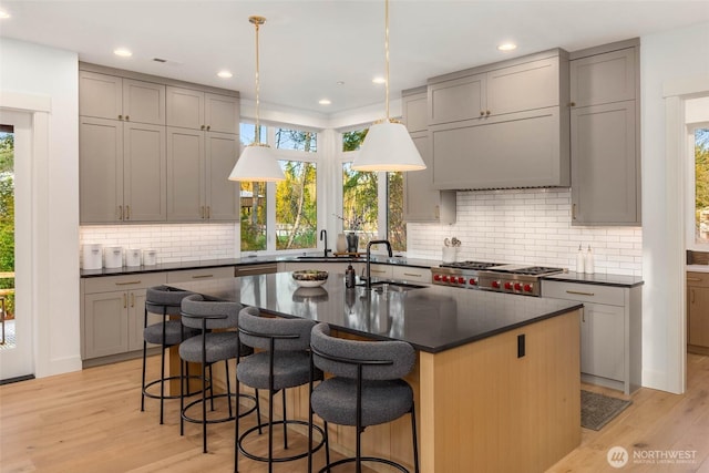 kitchen with a sink, dark countertops, and gray cabinets