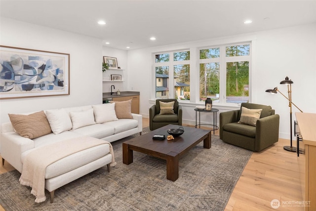 living area featuring recessed lighting and light wood finished floors