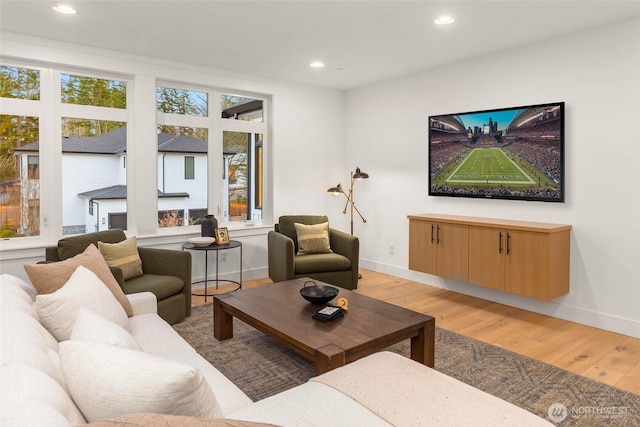 living room featuring recessed lighting, light wood-type flooring, and baseboards