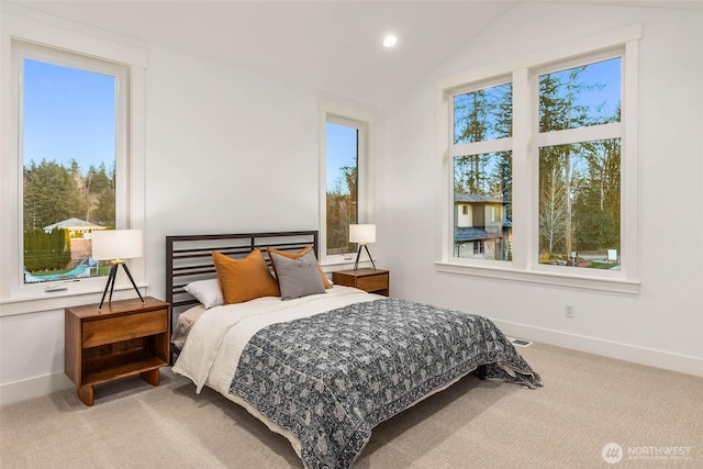 bedroom featuring carpet floors, multiple windows, and vaulted ceiling