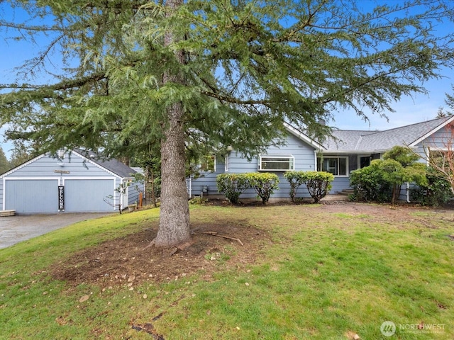 view of front of house with an outdoor structure and a front lawn