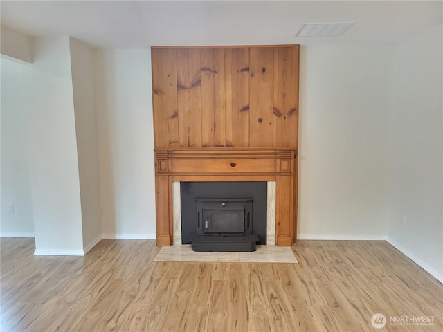 details featuring visible vents, wood finished floors, and baseboards