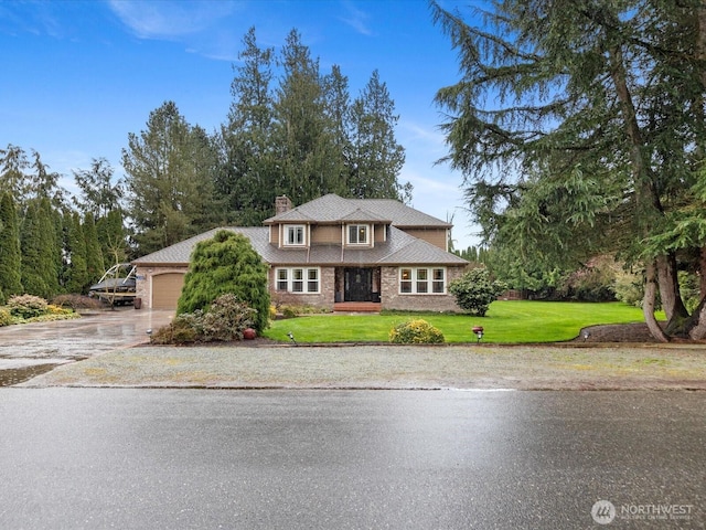 view of front of property featuring driveway, an attached garage, a chimney, and a front lawn