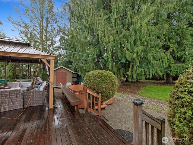 deck with a gazebo, an outdoor structure, and a shed