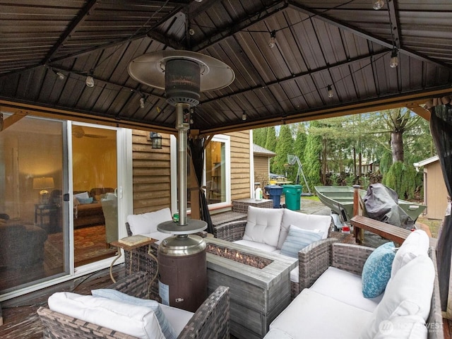 view of patio featuring an outdoor living space with a fire pit