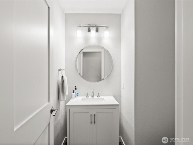 bathroom with vanity and a textured wall