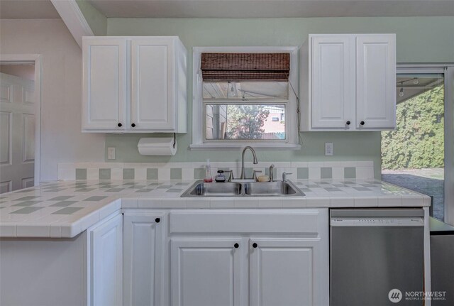 kitchen featuring a sink, tile countertops, white cabinetry, and stainless steel dishwasher