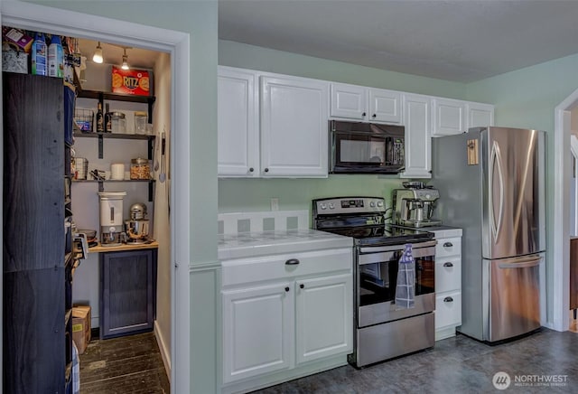 kitchen featuring tile counters, white cabinets, and appliances with stainless steel finishes