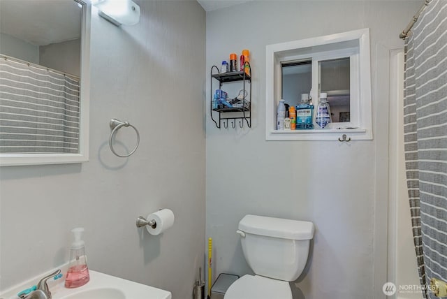 bathroom featuring toilet and a sink