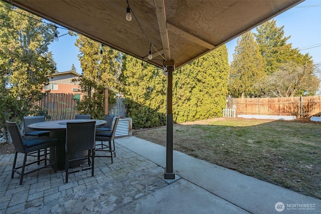 view of patio with outdoor dining area and fence