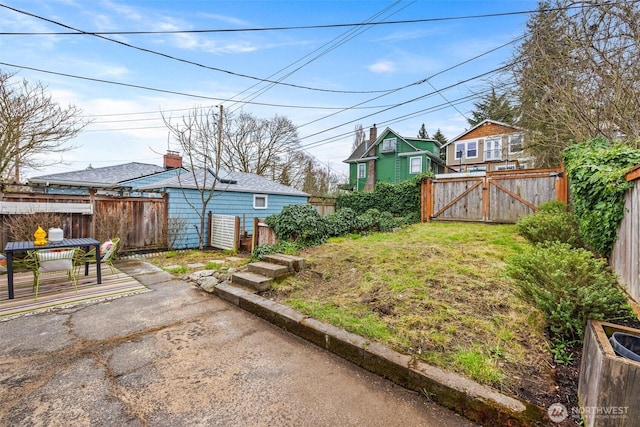 view of yard with a gate, fence, and a patio area