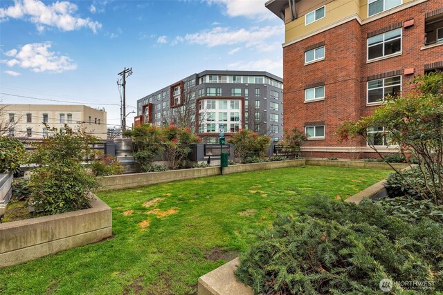 view of home's community featuring a garden and a lawn