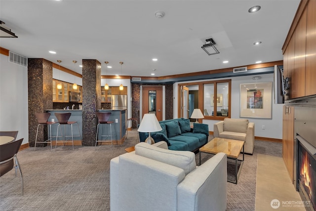 carpeted living room with recessed lighting, visible vents, and baseboards