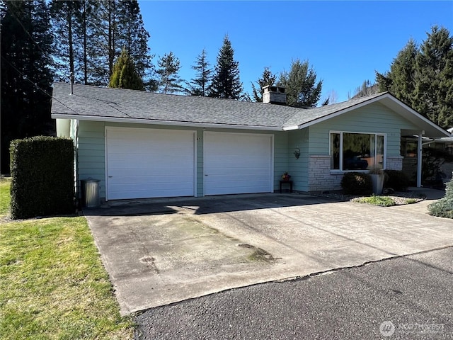 ranch-style house with a chimney, an attached garage, concrete driveway, and a shingled roof