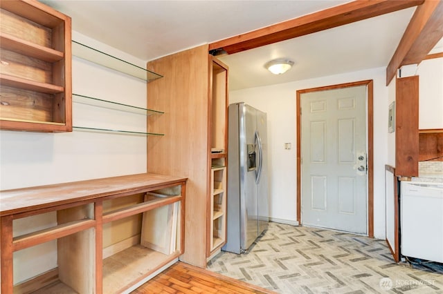 kitchen with open shelves, stainless steel fridge, and dishwasher