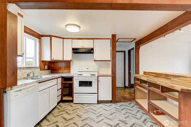 kitchen with under cabinet range hood, white cabinets, white appliances, and a sink