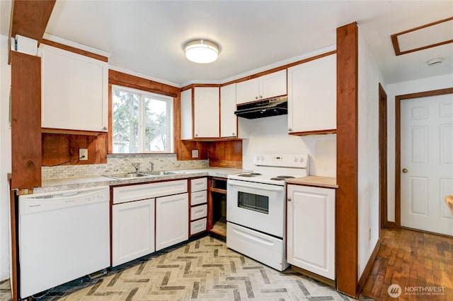 kitchen featuring white appliances, white cabinets, light countertops, and under cabinet range hood